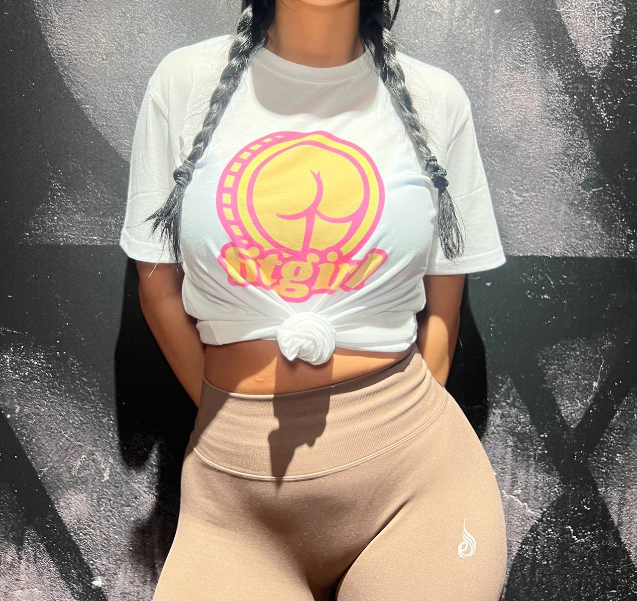 Model wearing the white fitgirl tee at the gym